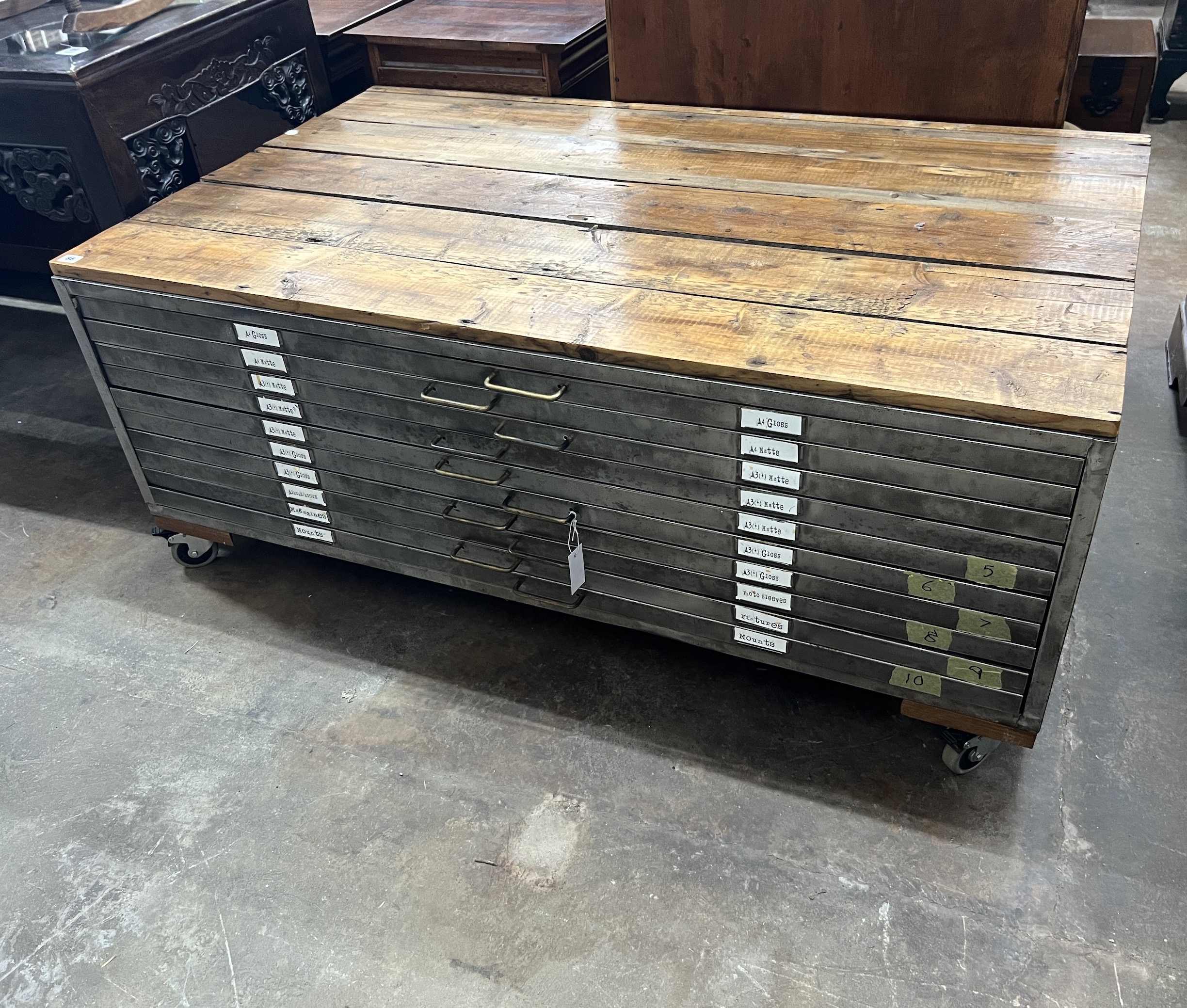A contemporary planked top steel ten drawer plan chest on locking wheels, width 147cm, depth 89cm, height 60cm